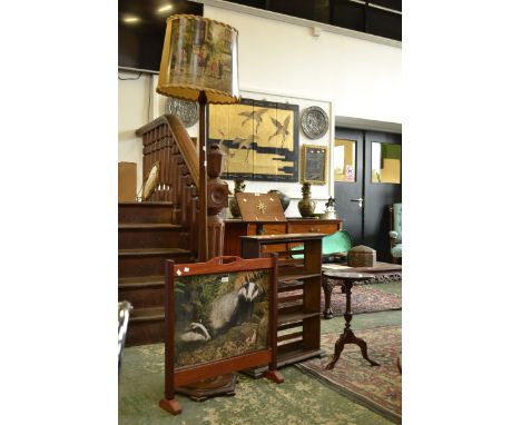 A mahogany standard lamp; a small oak book rack; a reproduction mahogany wine table; an oak framed firescreen (4)