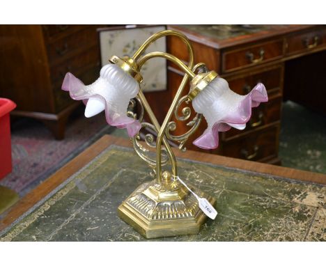 A Victorian brass two-branch table lamp, cranberry glass shades, c. 1890