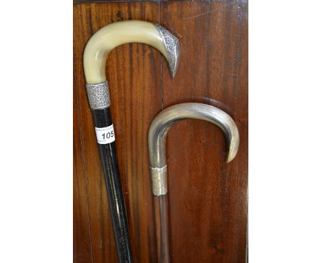 An early 20th century silver mounted walking stick, horn handle, silver collar, Birmingham 1921;  another, ebonised shaft,  B