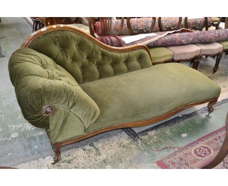 A Victorian mahogany chaise, shaped back rail, deep button upholstered scrolling arm and back, serpentine apron, cabriole sup