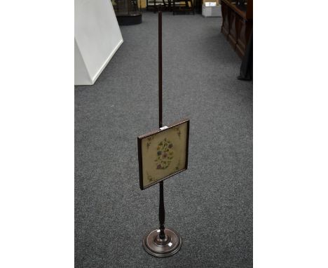 A Regency mahogany pole screen, square glazed screen with tapestry panel centre, turned column and foot