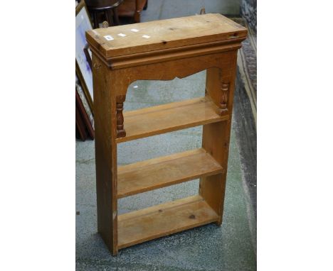A pine three shelf wall shelf.