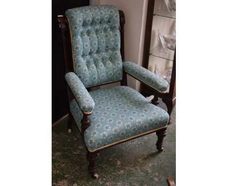 A Victorian mahogany salon chair, scrolling top rail, turned and fluted uprights, button upholstered back, padded open arms, 