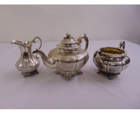 A Victorian three piece silver tea set to include a teapot, twin handled sugar bowl and milk jug of panelled form, floral and