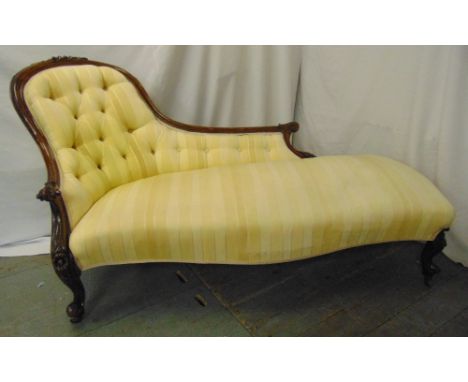 A Victorian upholstered chaise longue with button back on mahogany scroll feet