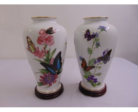 A pair of ceramic ovoid vases The Caribbean Butterfly by John Wilkinson on circular wooden stands