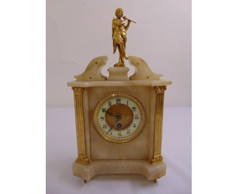 A Victorian alabaster and brass rectangular mantle clock surmounted by a classical figure playing a flute