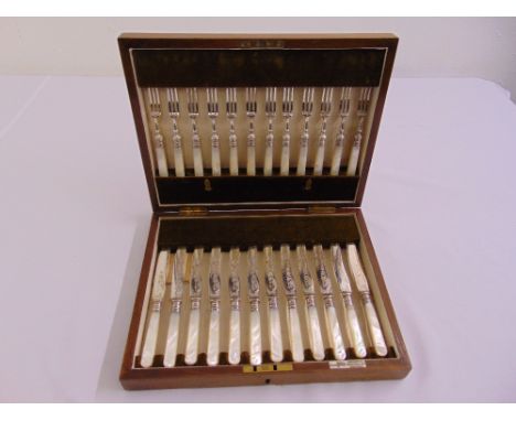 A mahogany cased set of Walker and Hall silver plated and Mother of Pearl dessert eaters for twelve place setting