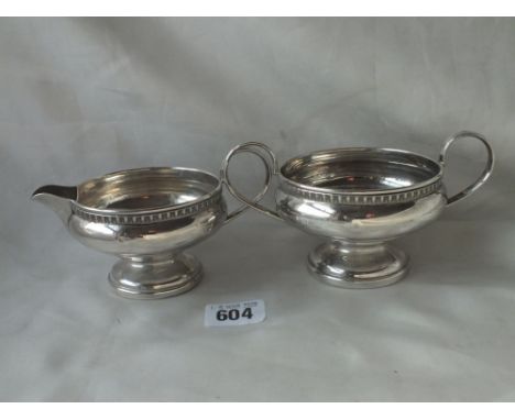 Pedestal cream jug, with egg and dart rim and a matching sugar basin, 6” over handles B’ham 1932 300g.   