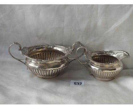 Cream jug and sugar basin, en-suite to the previous lot, 7.5” over handles 448g.