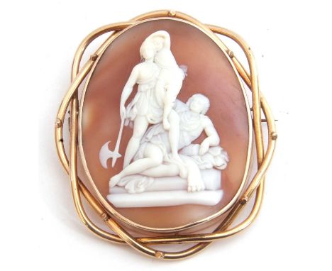 Victorian large carved shell cameo brooch depicting a family group standing with a man lying down, the lady holding a child i