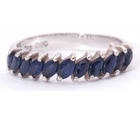 Modern 18ct white gold and sapphire half hoop ring featuring 11 faceted lozenge shaped sapphires, prong set, size O