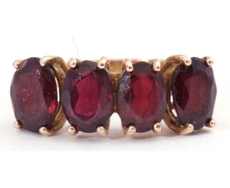 Garnet four stone ring, a row of uniform oval shaped faceted garnets, each individually four claw prong set, stamped 333, siz