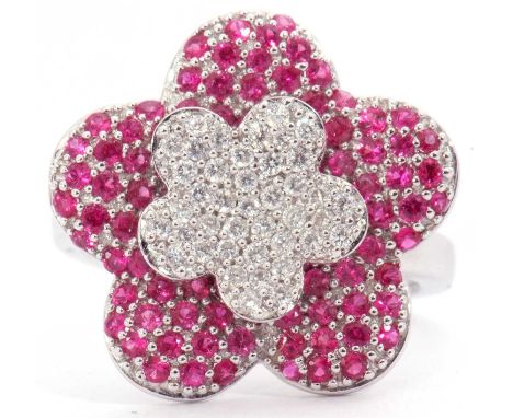 Modern diamond and ruby cluster ring, a large flowerhead design set throughout with small diamonds and rubies, stamped 750, s