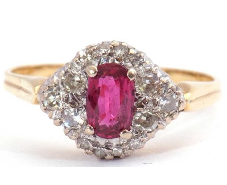 Ruby and diamond ring centring an oval cut ruby, 6.13 x 3.12 x 2.29mm, raised above a small diamond cluster surround, size L/