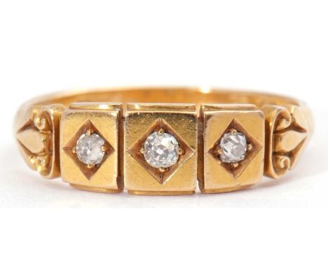 Victorian 18ct gold and diamond three stone ring, a three sectional panel design, each centring an old cut diamond in an engr