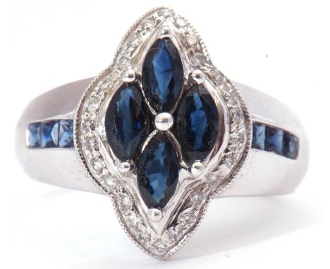 Modern sapphire and diamond cluster ring featuring four marquis shaped synthetic sapphires within a surround of small diamond