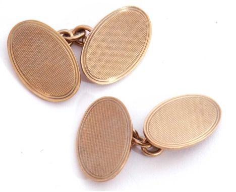 Pair of 9ct gold cuff links of oval shape, each panel with engine turned decoration, chain connectors, Birmingham 1967, 9gms