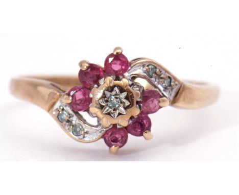 9ct gold ruby and diamond cluster ring, centring a small diamond in a star engraved illusion setting, raised above six small 