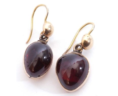 Vintage garnet set earrings, a cabochon teardrop garnet in cut down yellow metal mount suspended from a disc and shepherd hoo