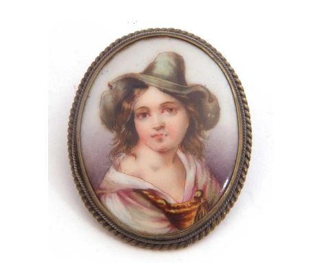 Vintage hand painted porcelain brooch of oval form depicting a young lady in a green hat, framed in a gilt metal mount (a/f)