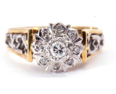 Diamond cluster ring centring a brilliant cut diamond, 0.15ct approx, raised above a small diamond surround, all in engraved 