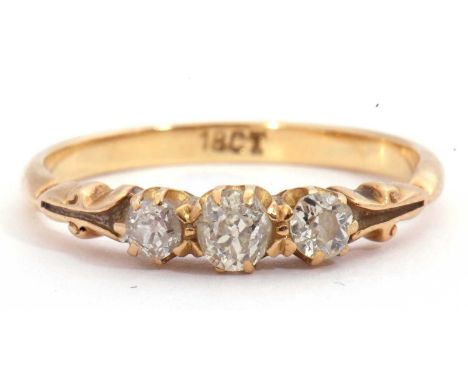 Three stone diamond ring featuring three graduated old cut diamonds, 0.35ct total, individually claw set in a carved gallery,