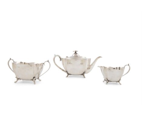 A THREE PIECE SILVER TEA SERVICE, Sheffield 1909, mark of George Wish, comprising: tea pot, sugar bowl and a creamer, each of
