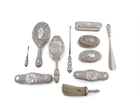 A COLLECTION OF SILVER MOUNTED TOILETTE ACCESSORIES, Birmingham, various dates, each piece embossed and chased with scroll an