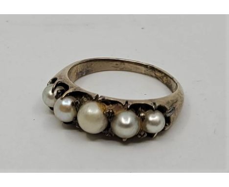 A precious yellow metal and pearl half-hoop ring, set five graduated pearls (yellow metal assessed as 14ct. gold, gross weigh