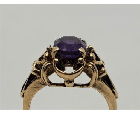 A 10ct. gold and amethyst ring, set mixed oval cut amethyst to centre. with wirework gallery and shoulders, stamped "10K", gr