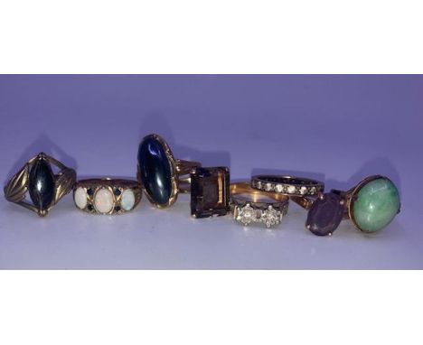 A collection of eight various gold rings, to include; 14ct. gold amethyst and 14ct. gold smokey topaz dress rings, 9ct. gold 