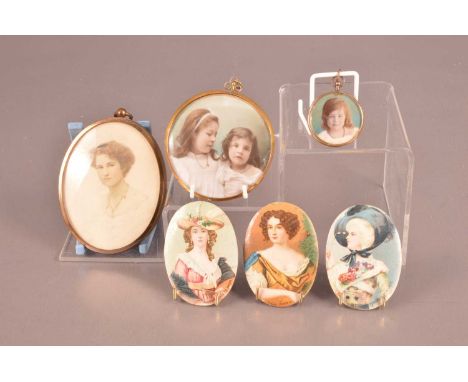 Three late Victorian and Edwardian photographic portrait miniatures, the largest in gilt metal frame with Edwardian lady phot