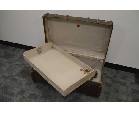 An early 20th Century leather and wood framed steamer trunk, linen interior with a single shelf within. British made, circa 1