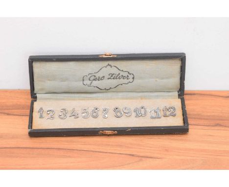 A cased set of continental silver number holders, 1-12 with hooks verso, in a Gero Silver fitted box