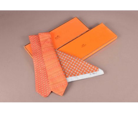 Two Hermes silk ties and a John Stefanidis cotton handkerchief, with two orange Hermes card boxes.