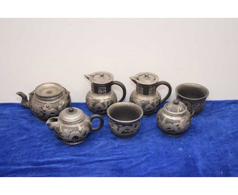 A mid 20th century Chinese black basalt and pewter mounted tea set, sugar basin with broken handle, some pieces marked Kung Y