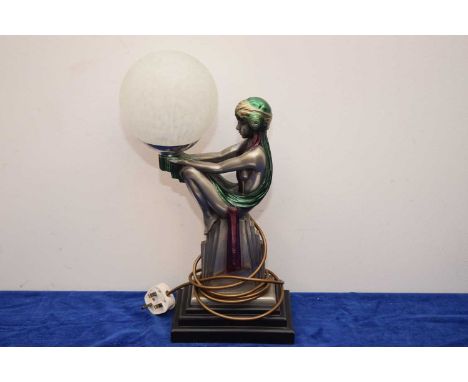 An Art Deco "Style" lamp, with elegant lady holding a glass spherical shade, 44cm