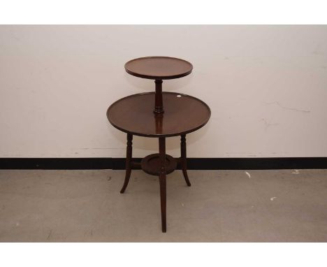 A Victorian mahogany dumbwaiter table, having a fixed upper tier and the lower on lazy Susan system, and decanter shelf to st