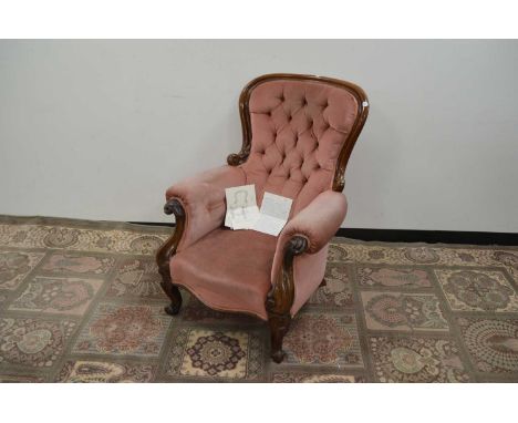 A late 19th Century pink velvet upholstered carved walnut armchair, button back etc.