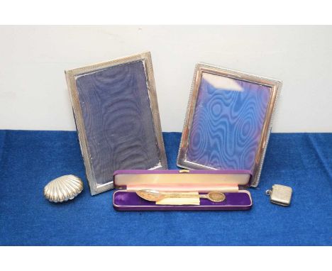 Five Victorian and later silver items, including a clam shaped purse, vesta case, two photograph frames and a spoon