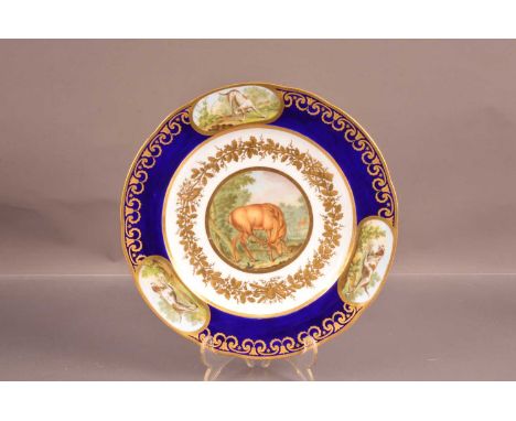 A late 19th century Sevres style plate, with painted images of a Stag and hunting dogs, with gild border, with mark to revers
