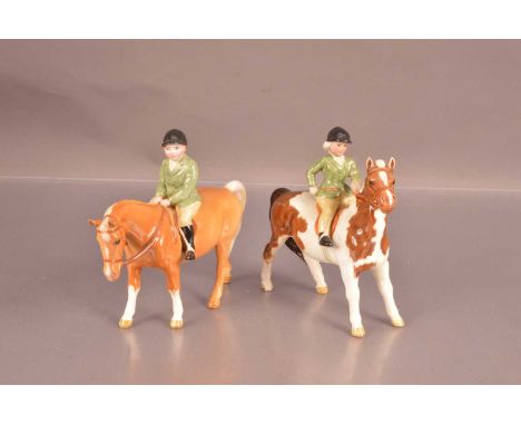 Two Beswick hunting figures, comprising a boy on a Palomino horse 1500 and a girl on a horse 1499, 13cm high (2)
