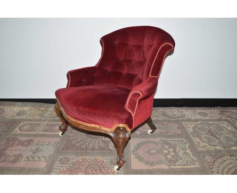 A late 19th Century burgundy velvet upholstered tub chair, of neat proportions with button back, mahogany legs etc