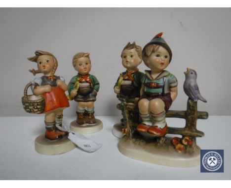 Four Hummel figures; Two boys with trumpets, girl with basket and Wayside Harmony