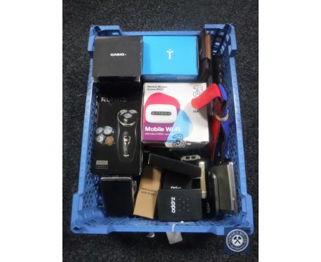 A basket of Zippo lighters, dart cases, leather wallet, BP monitor etc 