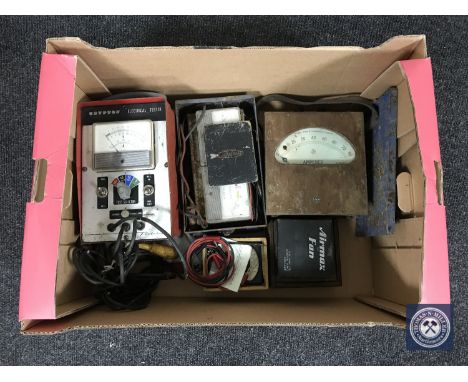 A box containing vintage voltmeters and ammeters 