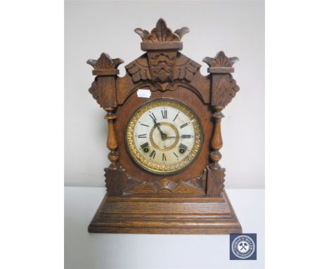 A carved oak American mantel clock by The Ansonia Clock Company of New York 
