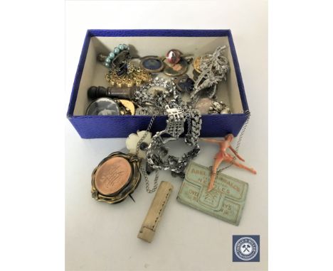 A box of assorted jewellery, vintage brooches, bottle lid, British Horse Society badge etc 