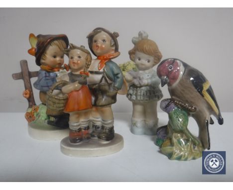 Two Hummel figures together with a Beswick Goldfinch and a figure of Mable Lucie Attwell.. (4)